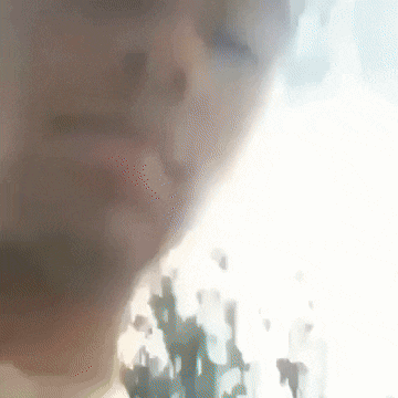 a blurry picture of a person 's face with a white background