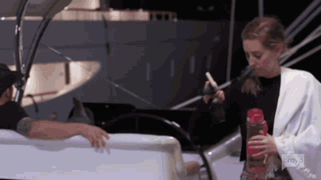 a woman on a boat with bravo written on the bottom of her shirt
