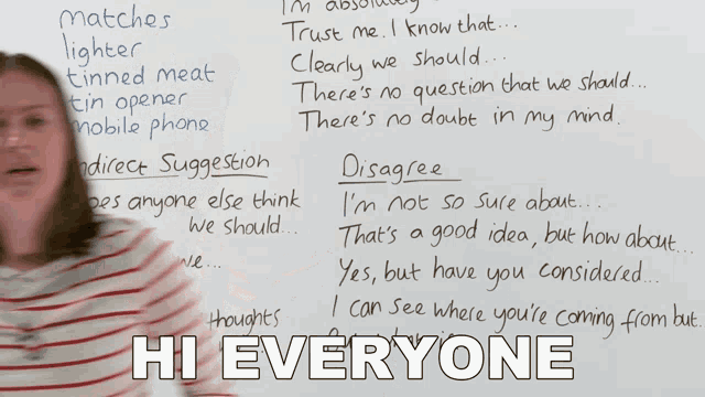 a woman stands in front of a whiteboard with the words hi everyone written on it