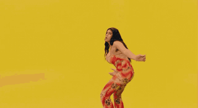 a woman 's back is shown with a yellow background