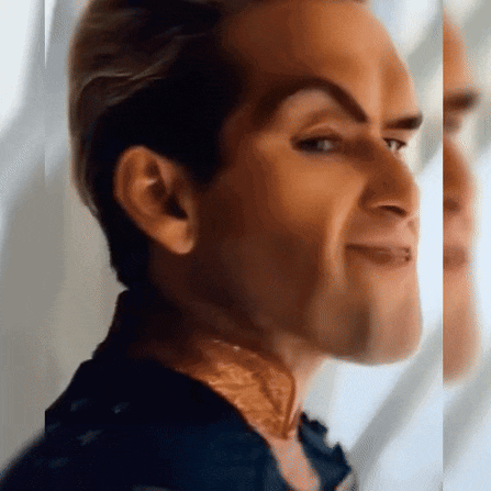 a close up of a man 's face with a slight smile