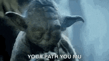 a close up of a statue of yoda smoking a cigarette .