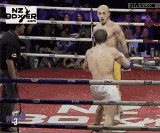 a boxer in a ring with a sign that says nz boxer.com