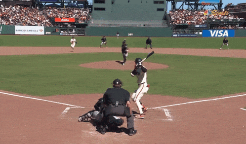 a baseball game is being played in front of a visa ad