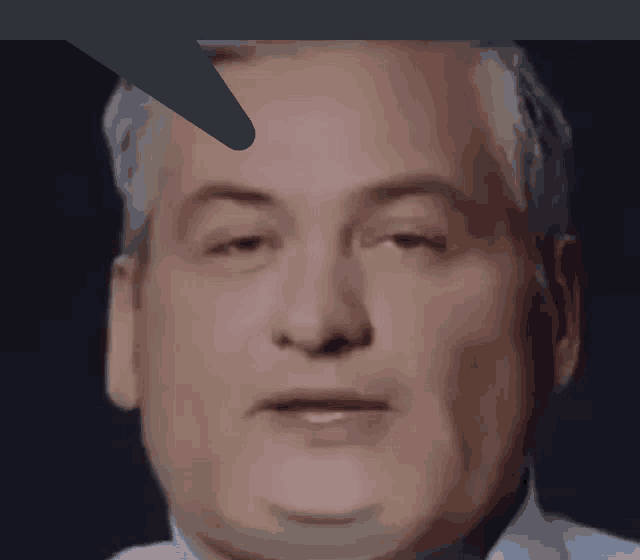 a close up of a man 's face with a pencil pointing to the forehead