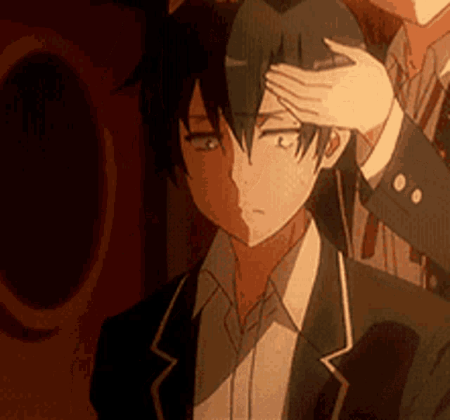 a man in a suit is being touched by another man 's hand .
