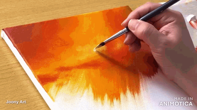 a person is painting on a canvas with the words made in animatica visible
