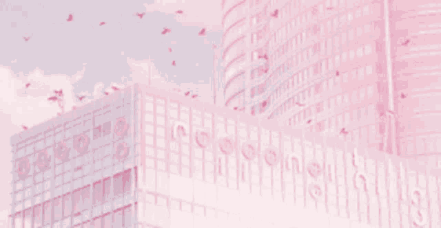 a flock of birds are flying over a pink building .