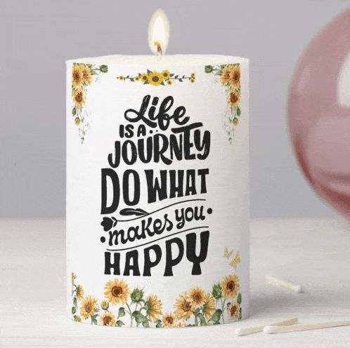 a white candle with sunflowers and the words life is a journey do what makes you happy
