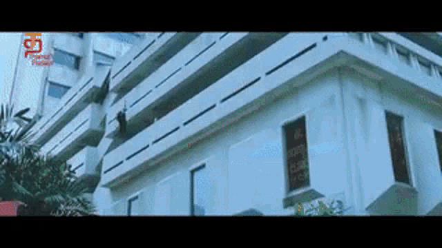 a man is jumping off the side of a building