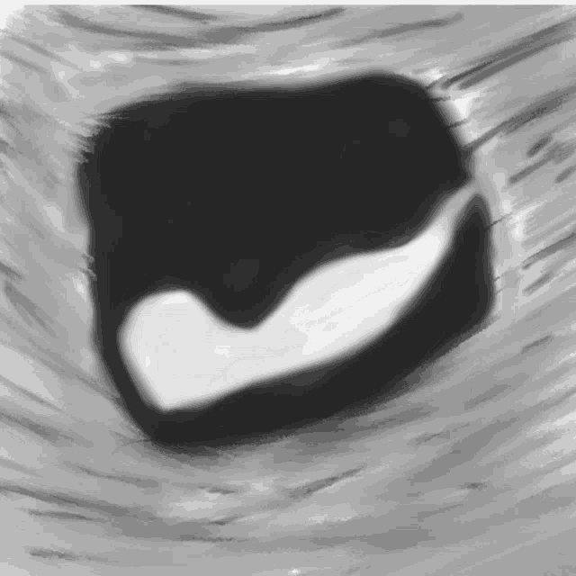 a black and white drawing of a heart on a gray surface