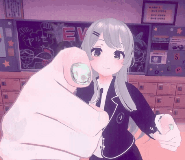a hand pointing at a girl in front of a blackboard that says ev on it