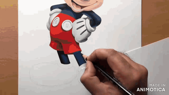 a person is drawing mickey mouse with a pencil