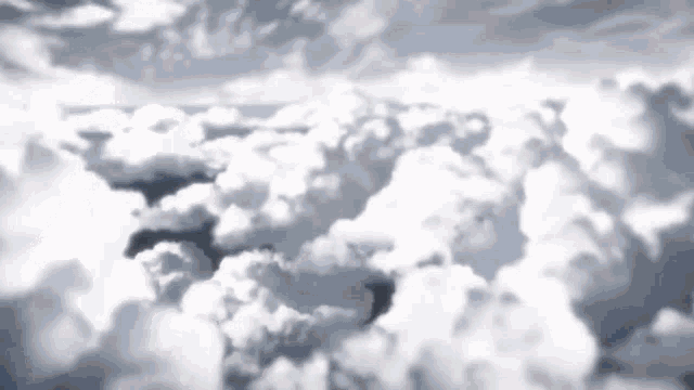 a view of a cloudy sky from an airplane window .