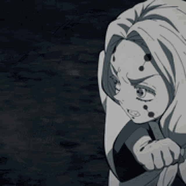 a woman with spider webs on her face is holding a knife in her hand .