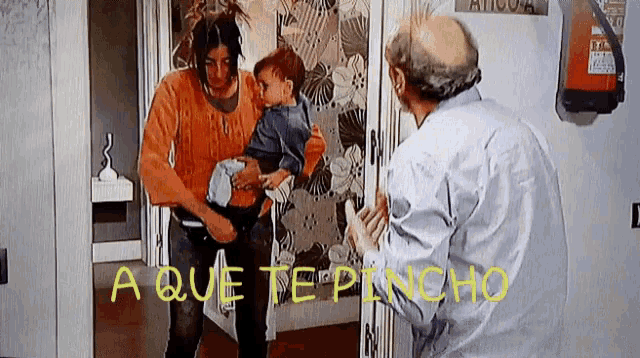 a woman holding a child standing next to a man with the words " a que te pancho " on the bottom