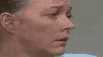 a close up of a woman making a funny face with her eyes closed .