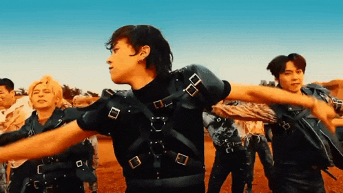 a group of young men are standing next to each other in a desert .
