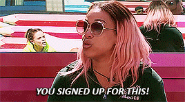 a woman with pink hair is wearing sunglasses and a shirt that says you signed up for this