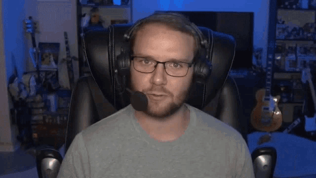 a man wearing glasses and headphones with a microphone on his head