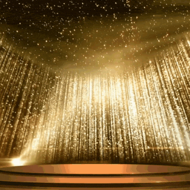 a stage with a gold curtain behind it and a podium in front of it