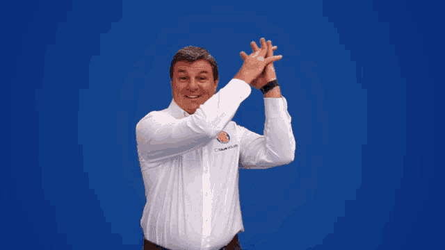 a man wearing a white shirt that says ' chevrolet ' on it