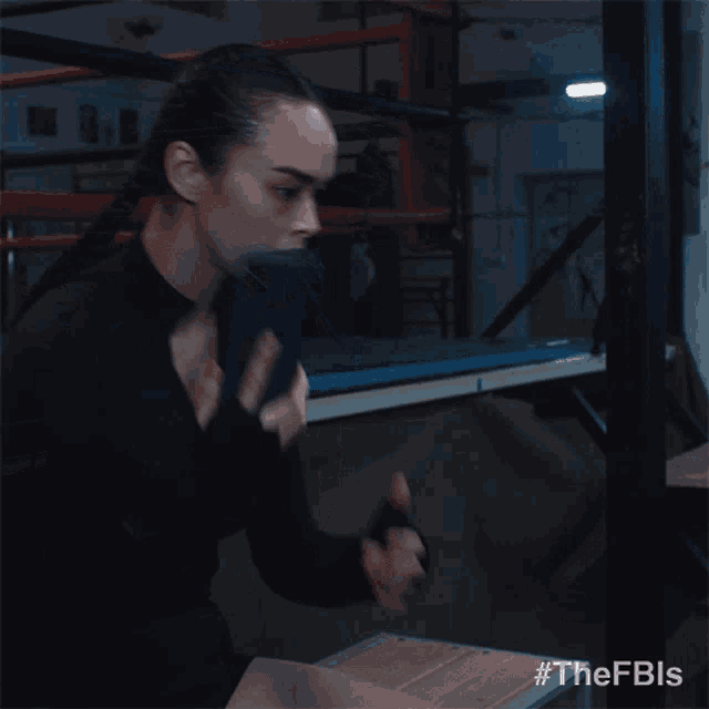 a woman talking on a cell phone in a dark room with the hashtag #thefbls