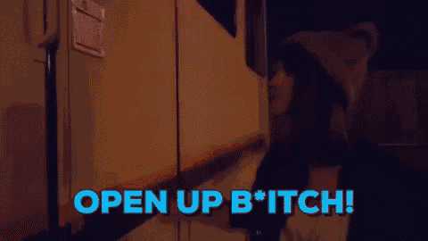 a person is standing in front of a door with the words open up bitch written on it