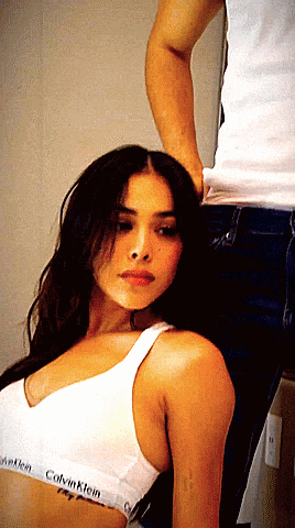 a woman wearing a white calvin klein bra