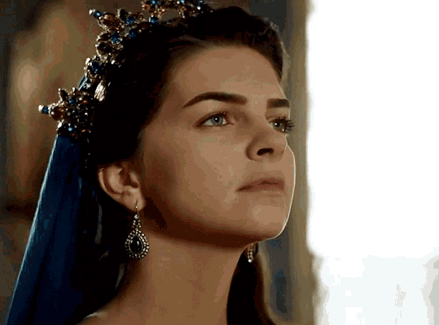 a woman wearing a blue veil and a crown