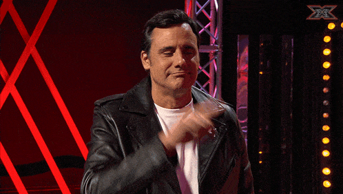 a man in a black leather jacket says " quienes somos nosotros "