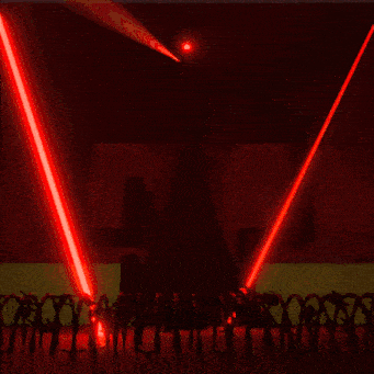 a group of people are standing in front of a sign that says star wars