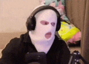 a man wearing a ski mask and headphones is playing a video game .