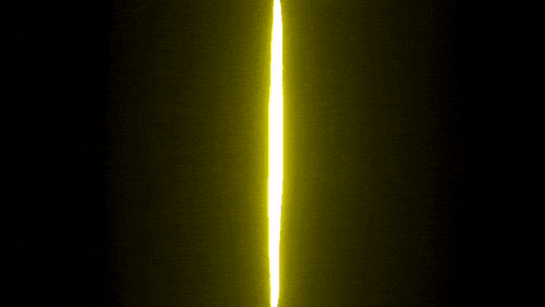 a yellow light beam is coming out of a dark room