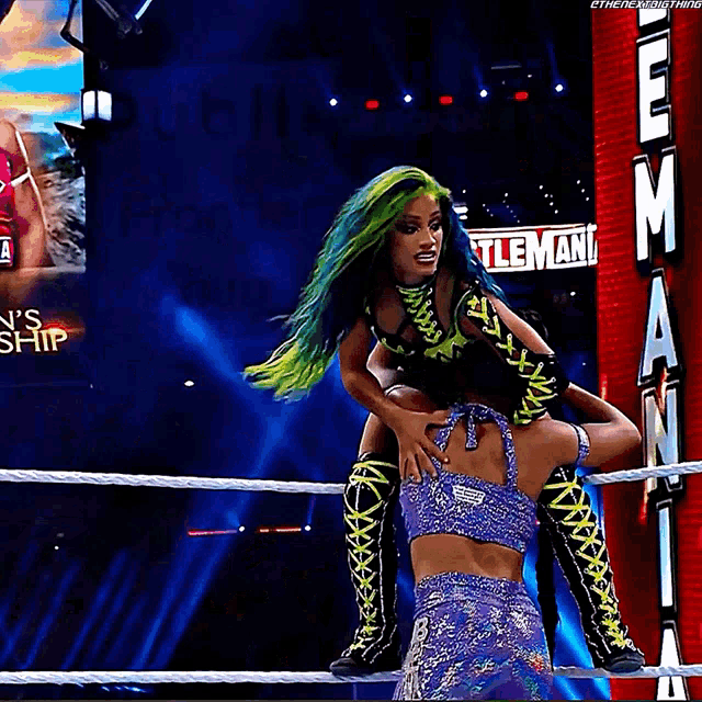 a woman with green hair is being lifted in the air by another woman