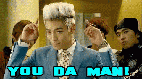 a man in a suit and tie with the words you da man behind him