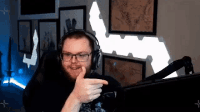 a man wearing headphones giving a thumbs up