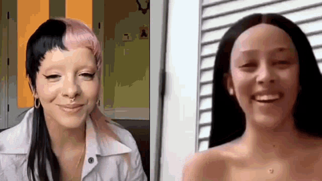 two women are sitting next to each other and smiling .