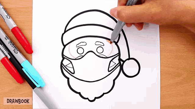 a person is drawing a santa claus wearing a mask