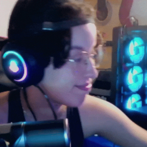 a woman wearing headphones and glasses is smiling in front of a computer case
