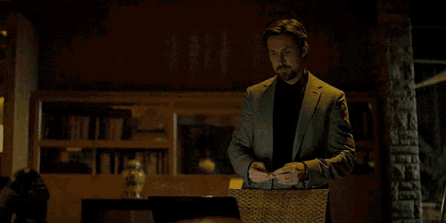 a man in a suit is holding a piece of paper