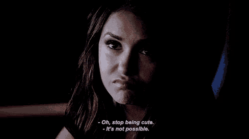 a woman is making a funny face in the dark and says `` oh , stop being cute . ''