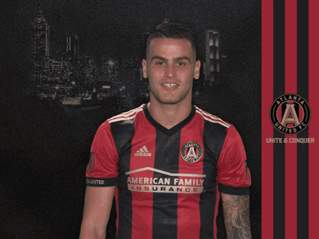 a man wearing an atlanta united fc jersey