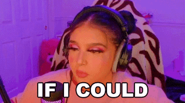 a woman wearing headphones is sitting in front of a microphone and says if i could