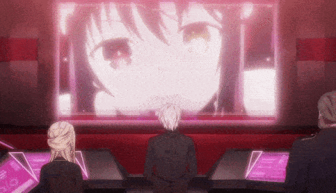 a group of people are looking at a large screen with a girl 's face on it