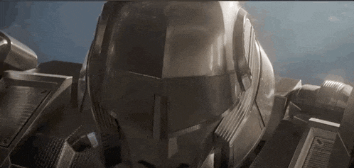 a close up of a robot 's helmet with a blue background .