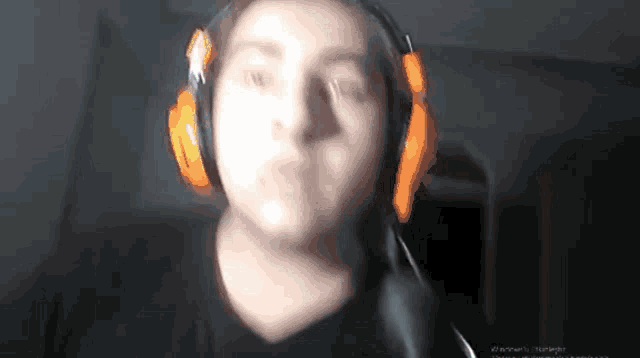 a blurry picture of a person wearing headphones and a black shirt