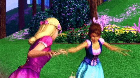 two barbie dolls are standing next to each other in a garden