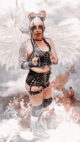 a woman with white wings is giving a thumbs up sign
