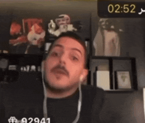 a person wearing headphones with the time 02:52 on the bottom of the screen